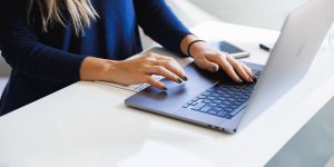As an Example of Technical Writing, a Woman Typing on Her Laptop